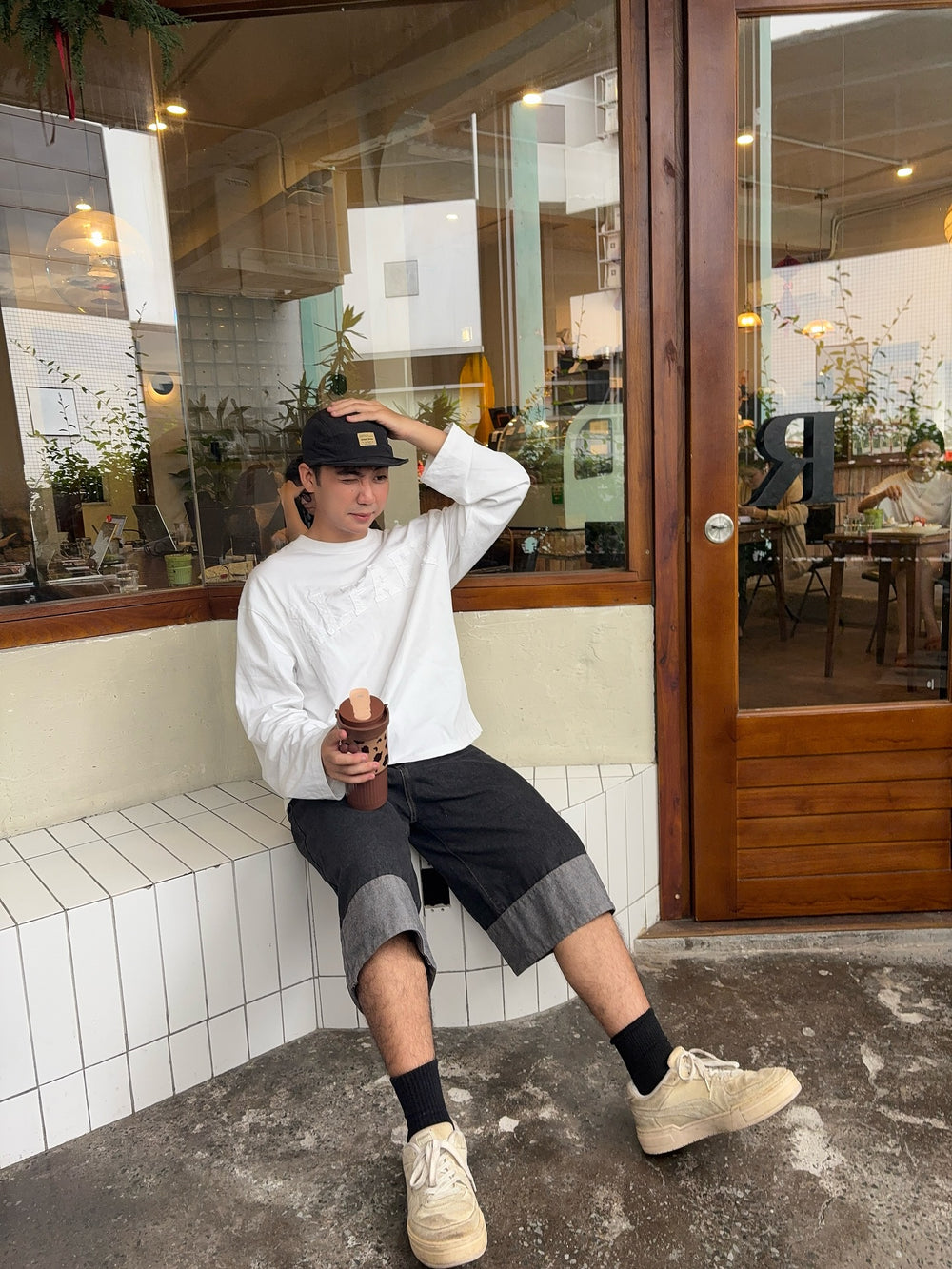 KADA Club creator styling a tumbler with a relaxed cafe outfit